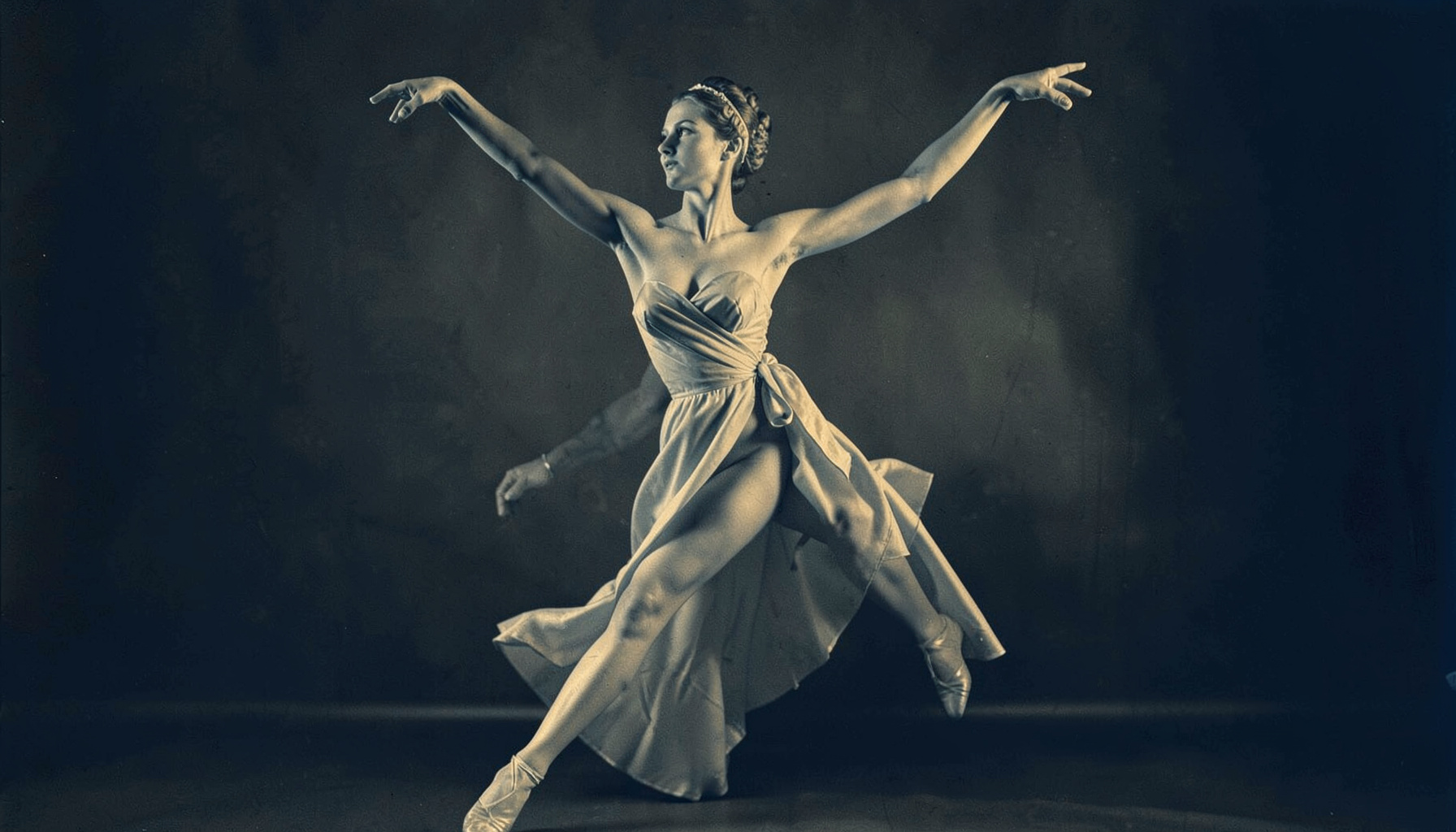 Duotone of a classical dancer in an elegant stance, warm amber and navy palette
