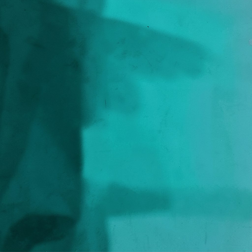 Smartphone on a wooden surface with audio waveform visible, intimate practice-space duotone